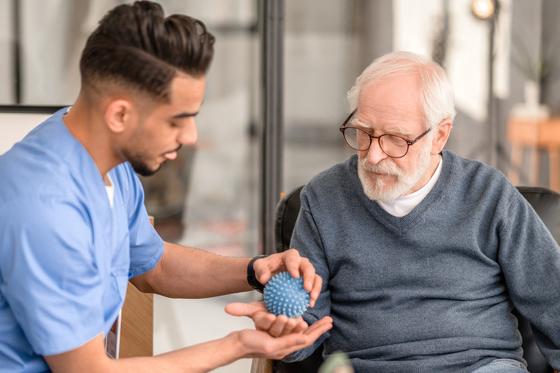 Concentrated physiatrist conducting a physiotherapy session